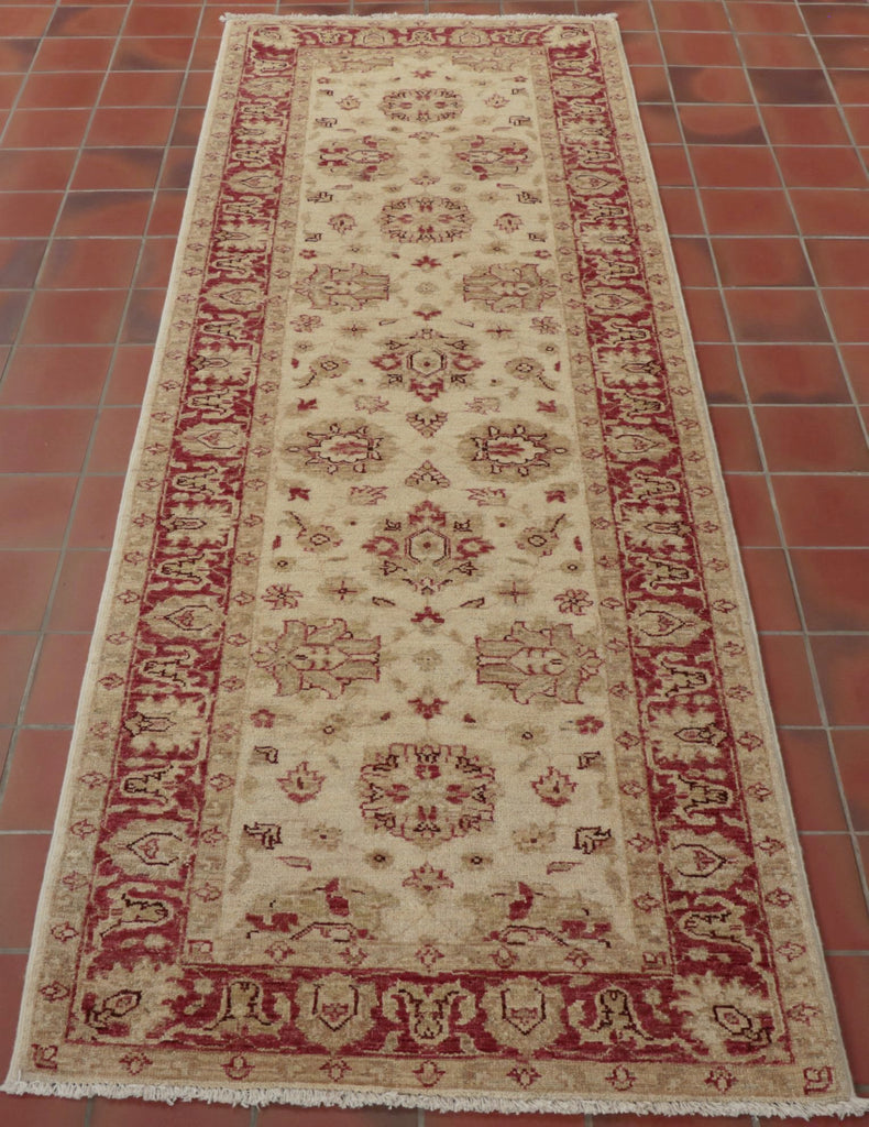 This runner will bring light and warmth to any hallway or landing.  A pinky red is used in the border and in some of the floral decoration. There is a high level of decoration in the main ground. 