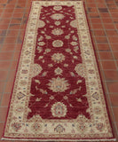Wine red central ground on this runner with shades of cream used in the border and in the decorative work in the central area.  Blue and green are used to highlight certain areas of the design work.