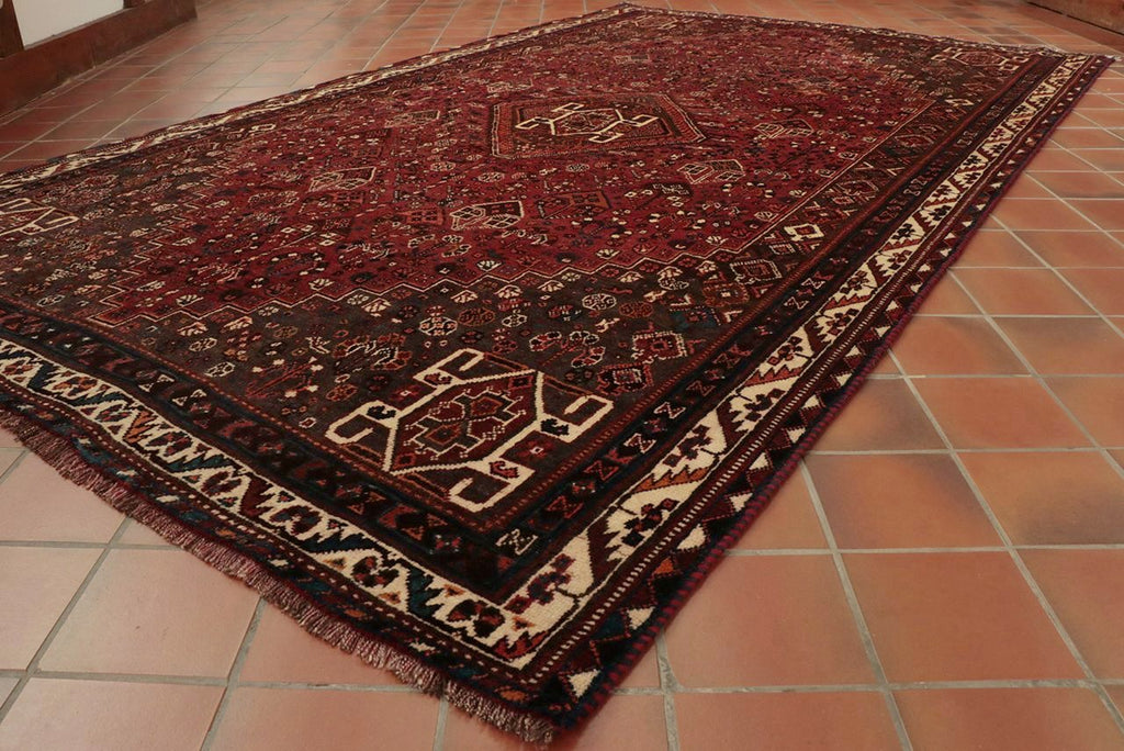 A hand knotted Persian Qashqai rug made from wool in traditional design.