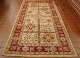 A russet red border with a classic Ziegler design.  The main area of the rug is split into sections, 2 by 6 layout.  There are three designs for the decoration inside of the boxes, all stylized floral designs.  Golden yellow and orange, with soft green are the main colours for the decorative work.   