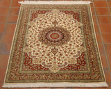 Flora and fauna decoration throughout this rug.  A large central section, round with inner decoration in greens, dark blue edging and red.  Surrounding this is an area of cream, again highly decorated and to each corner a red area.  There is a broad border, encased with two narrower ones using the same colour palette. 