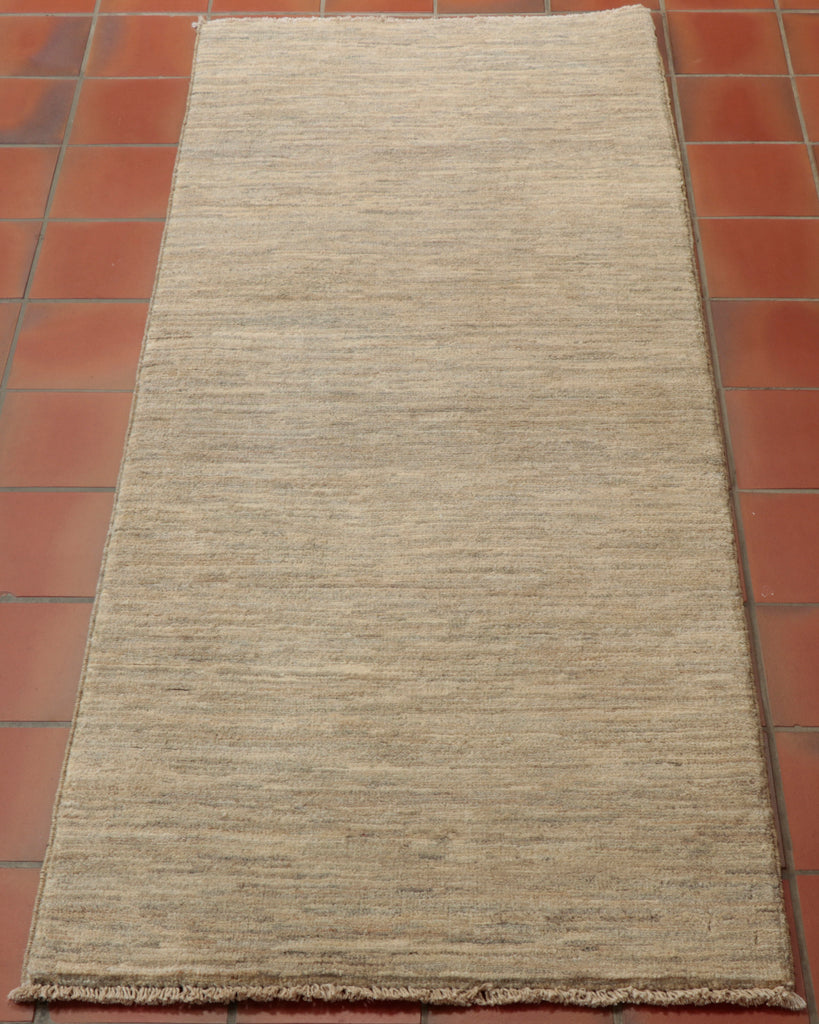 This Afghan Gabbeh runner is rather simplistic, possessing a textured mid-light grey colour throughout - perfect for those who want a handmade rug that is more modernistic.