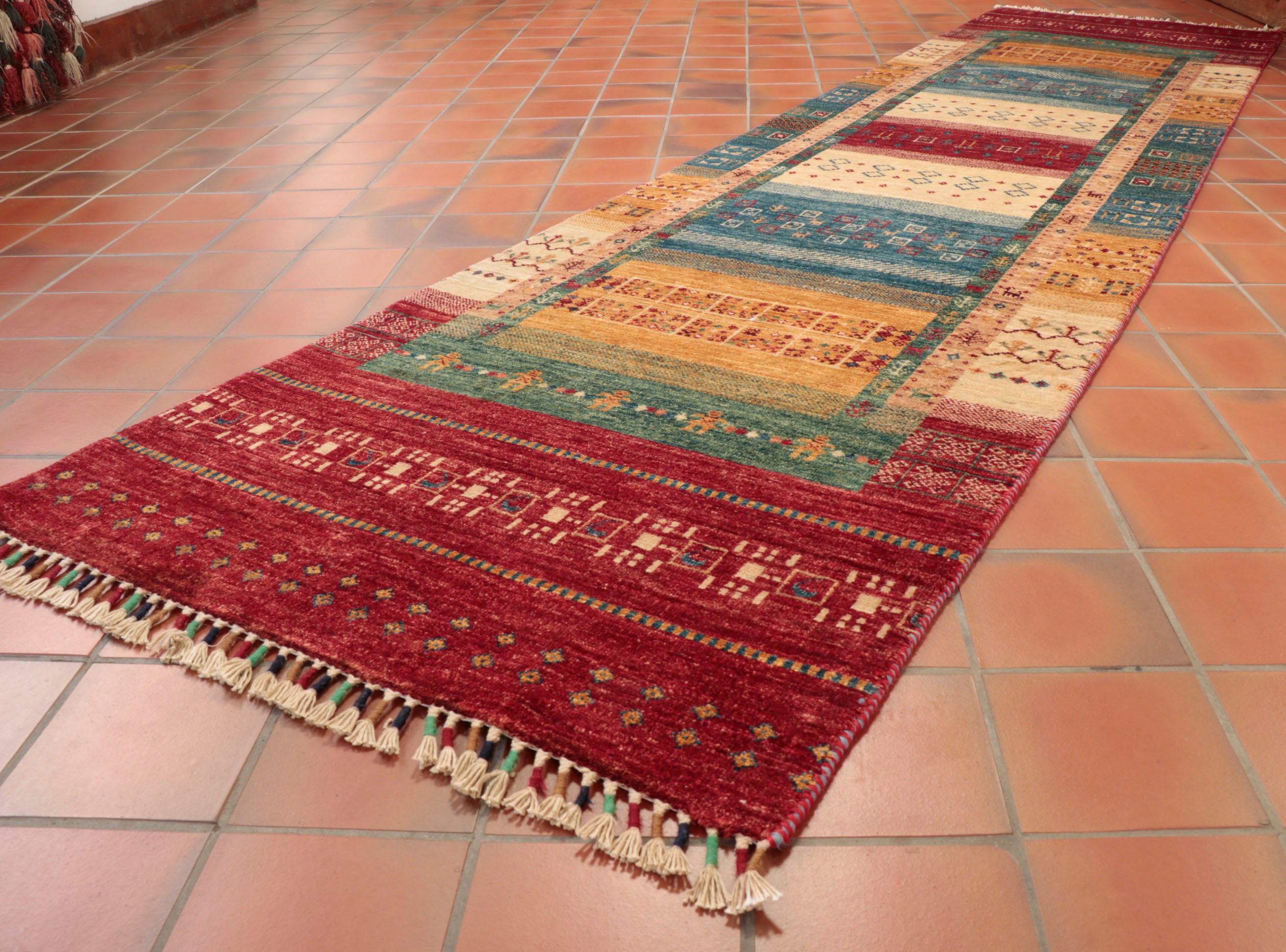 This long Afghan Loribaft runner is 315 x 80cm (10'4 x 2'8) in size