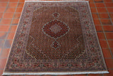 This Fine Persian Tabriz measures 150 by 105 centimetres.  The central medallion in a deep soft pink and is surrounded by a sophisticated design, something similar to designs seen at the Alhambra Palace in Andalucia. The colours used are all very soft and include a pink, peach, gold, green and rust, and the design being interwoven florals and small singular flowers. 