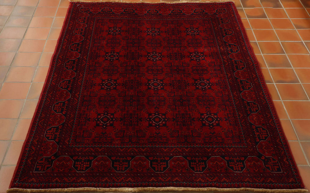 Very dark rich red with a dark blue used to draw out the design work.  The piece has a symmetrical pattern upon it.  12 motifs incased in interlocking patternwork are in the main area of the rug.  With a series of borders of differing widths and designs encasing this.  Cream is used as an edging to highlight certain areas of the decoration.   
