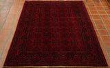 Very dark rich red with a dark blue used to draw out the design work.  The piece has a symmetrical pattern upon it.  12 motifs incased in interlocking patternwork are in the main area of the rug.  With a series of borders of differing widths and designs encasing this.  Cream is used as an edging to highlight certain areas of the decoration.   