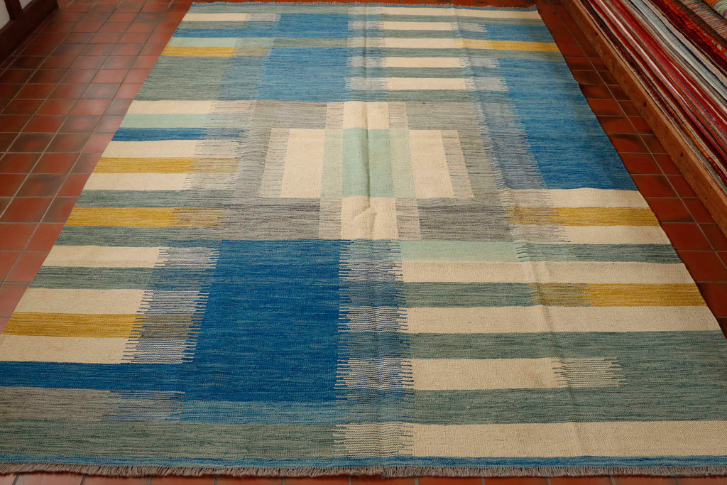 This kilim is absolutely unique, it suggests a colour palette that you might see on the coast. The main colour is blue with shades of sea grass gold and cream. the simple appearance of this design makes this piece quite stunning.