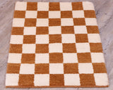 This small mat has a chequerboard design across it using cream and tan. 