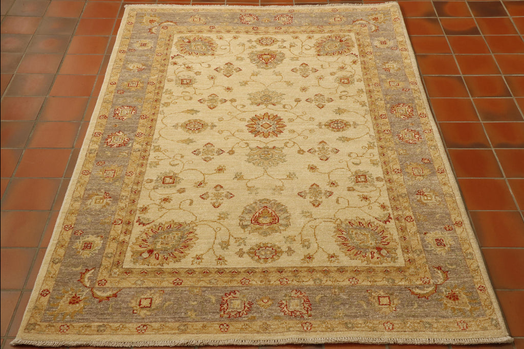  Cream ground fine Afghan Ziegler rug has a nod to the more up to date colour schemes as the outer border is a lovely gentle grey. Addition of warm buttermilk. Decoration connecting floral motifs. 